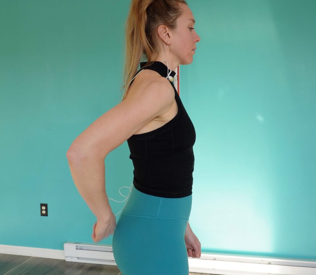 Dr. Chloe demonstrating how to place your hand behind your back for the internal rotation exercise